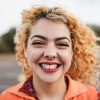 happy-young-girl-smiling-on-camera-outdoor-focus-on-face.jpg